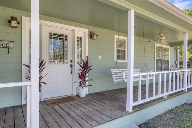 entrance to property with ceiling fan and a porch