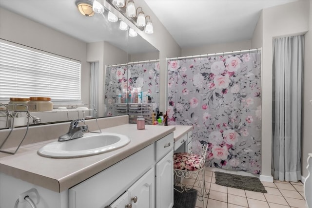 bathroom featuring tile flooring and vanity with extensive cabinet space