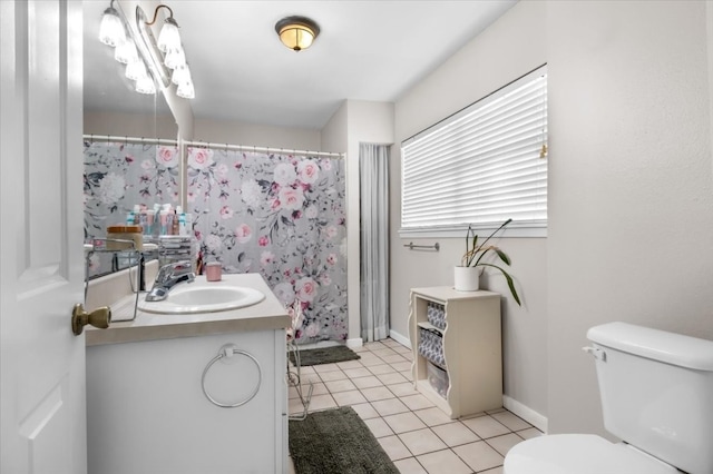 bathroom featuring tile floors, toilet, and large vanity