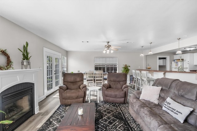 living room with ceiling fan, french doors, and hardwood / wood-style flooring