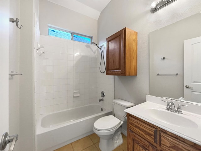 full bathroom with tile flooring, toilet, tiled shower / bath combo, and vanity with extensive cabinet space