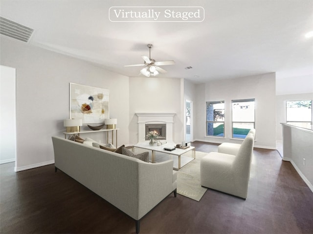 living room featuring ceiling fan and dark hardwood / wood-style floors