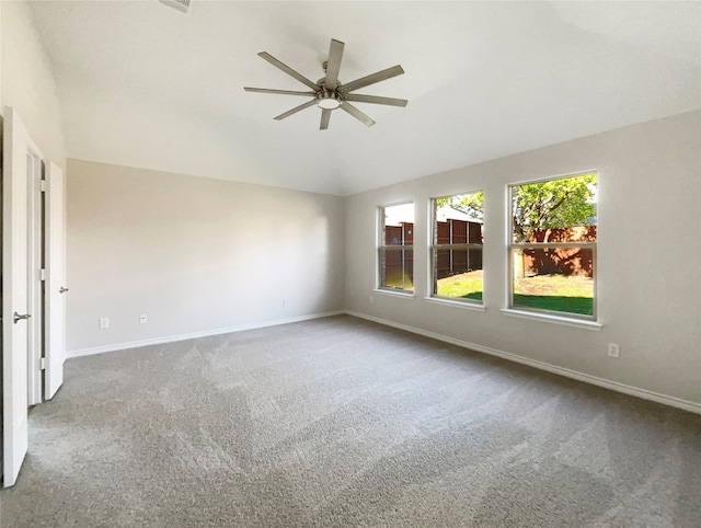 carpeted spare room featuring lofted ceiling and ceiling fan