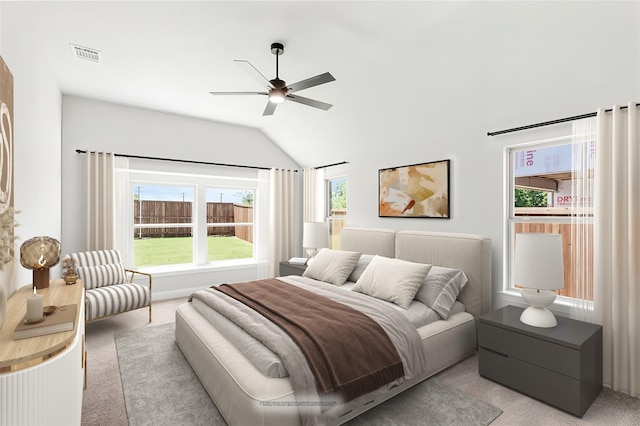 bedroom with ceiling fan, light carpet, and vaulted ceiling