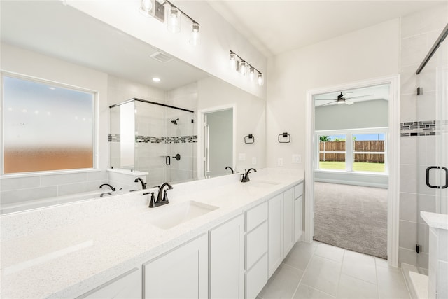 bathroom featuring tile patterned flooring, vanity, ceiling fan, and an enclosed shower