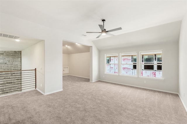 carpeted spare room featuring ceiling fan and lofted ceiling