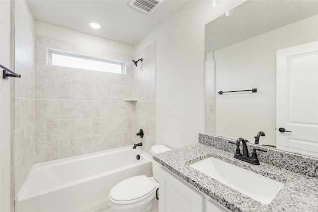 full bathroom with vanity, tiled shower / bath combo, and toilet