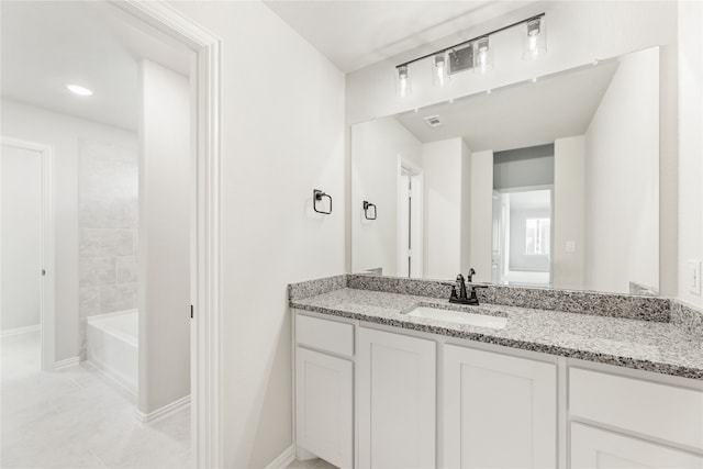 bathroom with tile patterned flooring and vanity