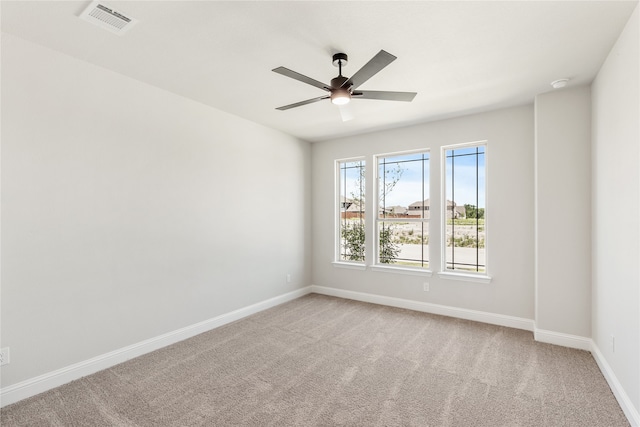 carpeted spare room featuring ceiling fan