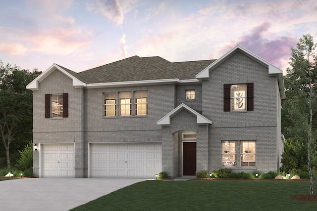 view of front of house featuring a yard and a garage