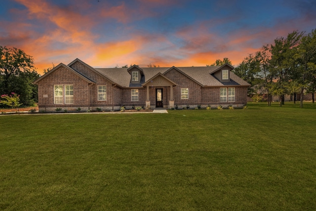 view of front of home with a lawn