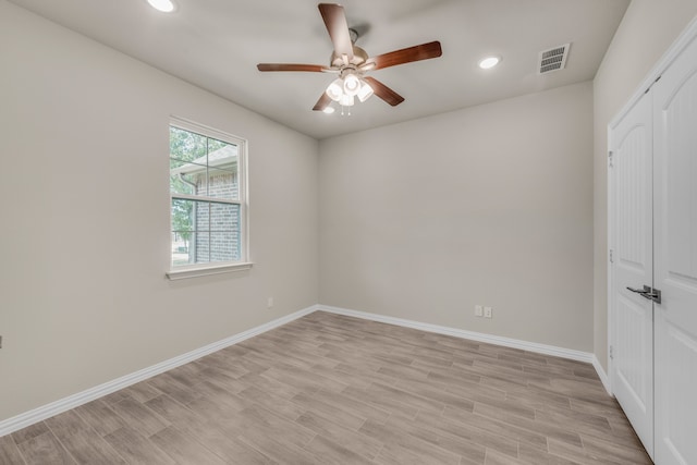 spare room with light hardwood / wood-style flooring and ceiling fan