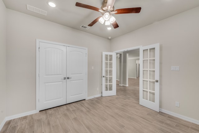 unfurnished bedroom with light wood-type flooring, french doors, ceiling fan, and a closet