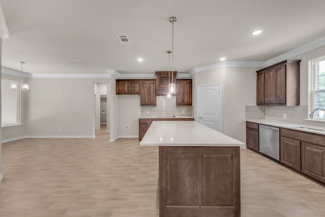 kitchen with decorative backsplash, dishwasher, and a center island