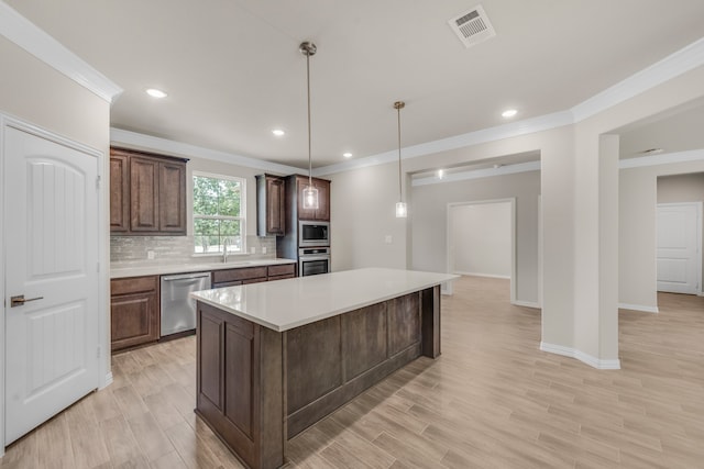 kitchen with light wood-type flooring, a kitchen island, stainless steel appliances, decorative backsplash, and pendant lighting