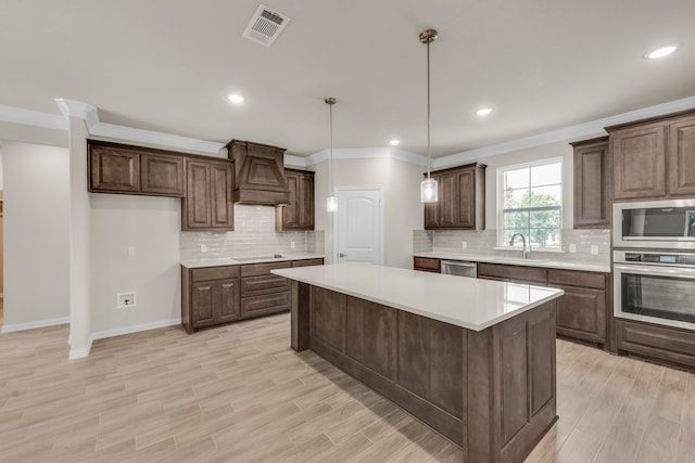 kitchen with ornamental molding, custom exhaust hood, decorative backsplash, and stainless steel appliances