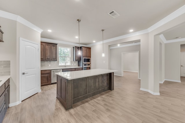 kitchen with light hardwood / wood-style flooring, tasteful backsplash, a kitchen island, stainless steel appliances, and hanging light fixtures