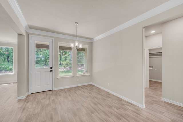 interior space with a healthy amount of sunlight, light wood-type flooring, and an inviting chandelier