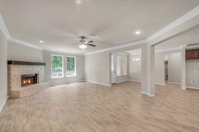 unfurnished living room with light hardwood / wood-style floors, ornamental molding, a fireplace, and ceiling fan