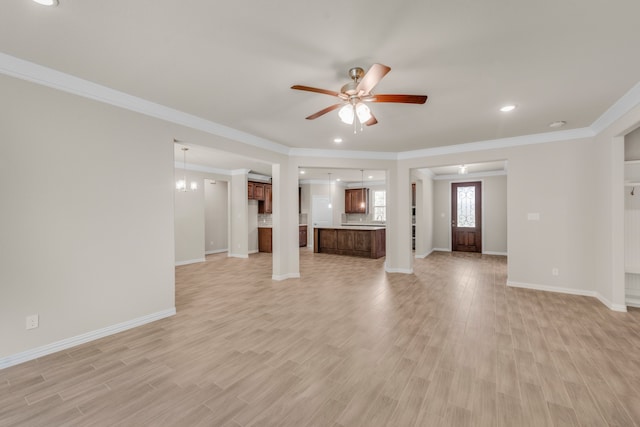 unfurnished living room with light wood-type flooring, ceiling fan, and ornamental molding