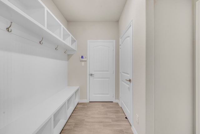 mudroom with light hardwood / wood-style floors