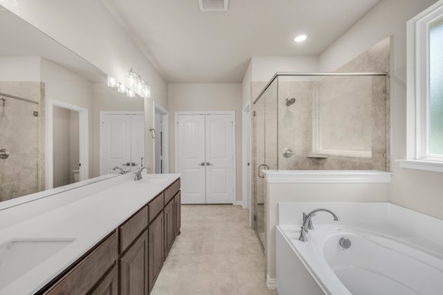 bathroom featuring independent shower and bath, tile patterned floors, and dual bowl vanity