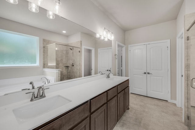 bathroom with tile patterned flooring, separate shower and tub, and dual bowl vanity