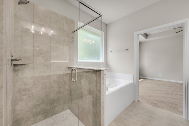 bathroom featuring separate shower and tub and hardwood / wood-style floors