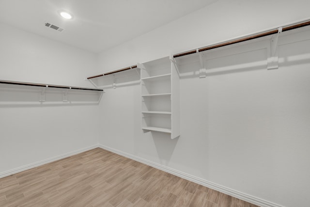 spacious closet featuring light hardwood / wood-style floors