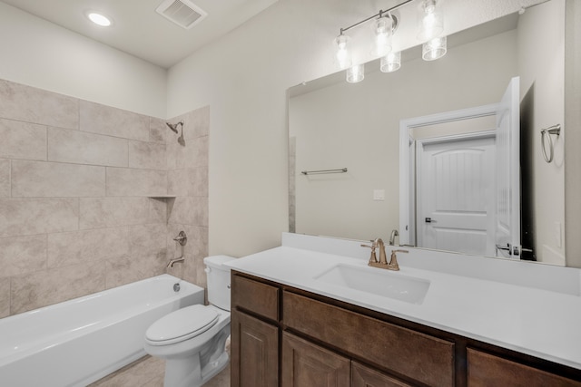 full bathroom with tile patterned flooring, toilet, tiled shower / bath combo, and vanity