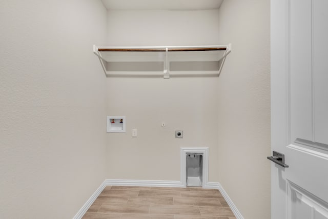 laundry area with gas dryer hookup, light hardwood / wood-style flooring, hookup for a washing machine, and hookup for an electric dryer