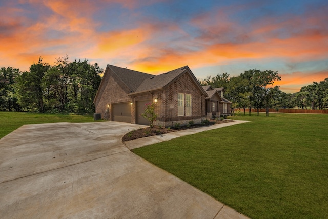 view of front of house featuring a garage and a lawn