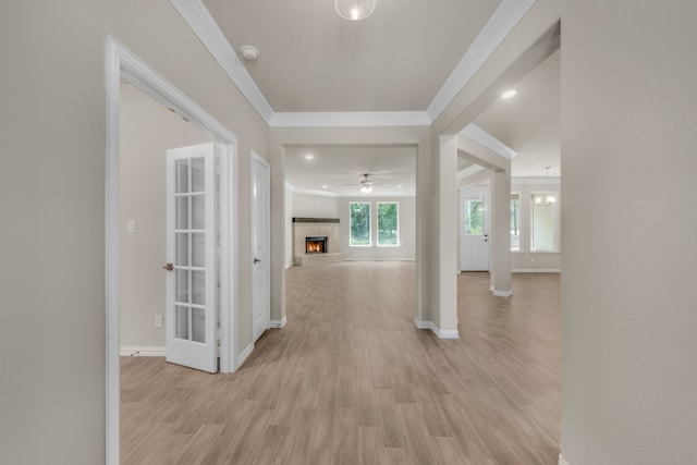 foyer entrance featuring ceiling fan, light hardwood / wood-style floors, and ornamental molding