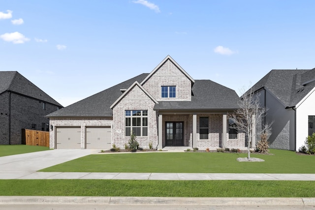 view of front of home with a front yard, a porch, and a garage