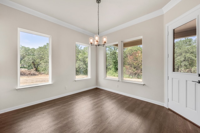 unfurnished dining area featuring dark hardwood / wood-style flooring, a chandelier, and ornamental molding