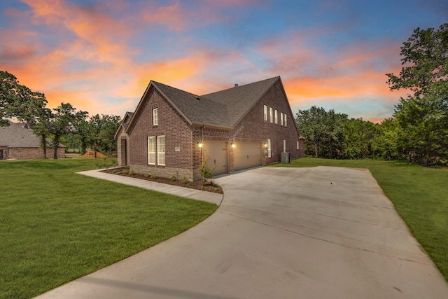 view of front facade with a garage and a lawn