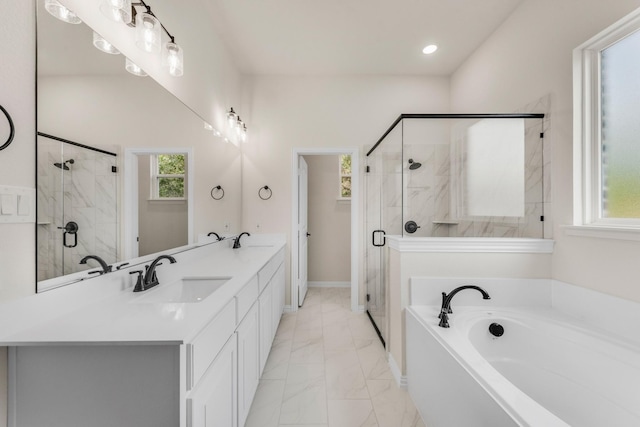 bathroom featuring vanity, shower with separate bathtub, and a wealth of natural light