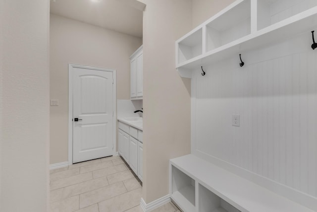 mudroom featuring light tile patterned floors and sink