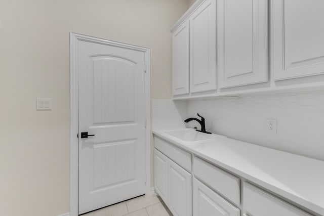 interior space featuring light tile patterned floors and sink