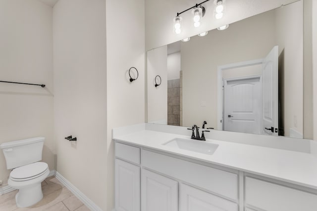 bathroom with vanity, tile patterned flooring, and toilet