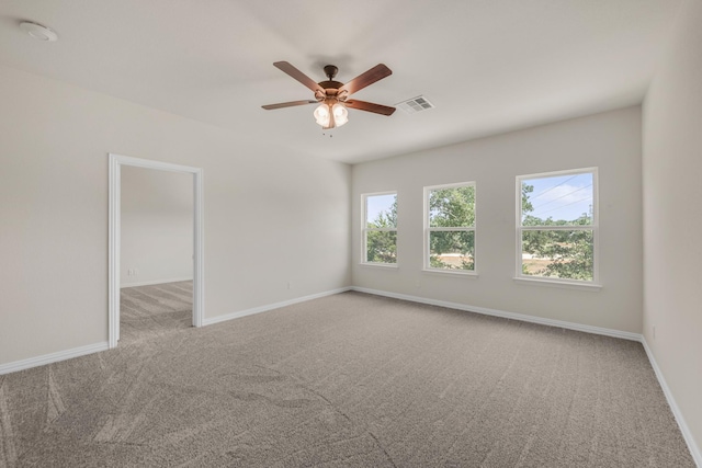 carpeted spare room with ceiling fan