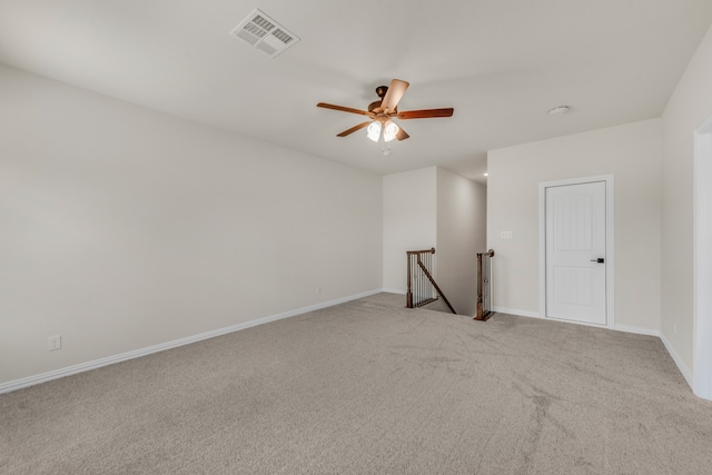 carpeted spare room featuring ceiling fan