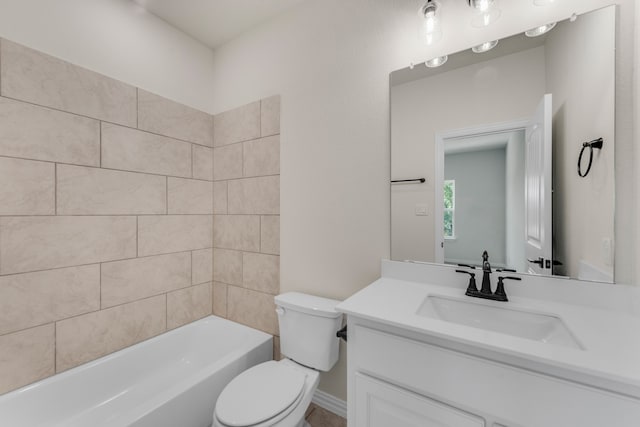 full bathroom with vanity, tiled shower / bath combo, and toilet