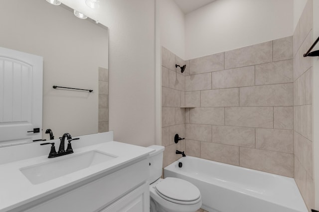 full bathroom featuring vanity, toilet, and tiled shower / bath combo