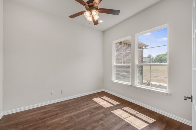 spare room with dark hardwood / wood-style floors and ceiling fan