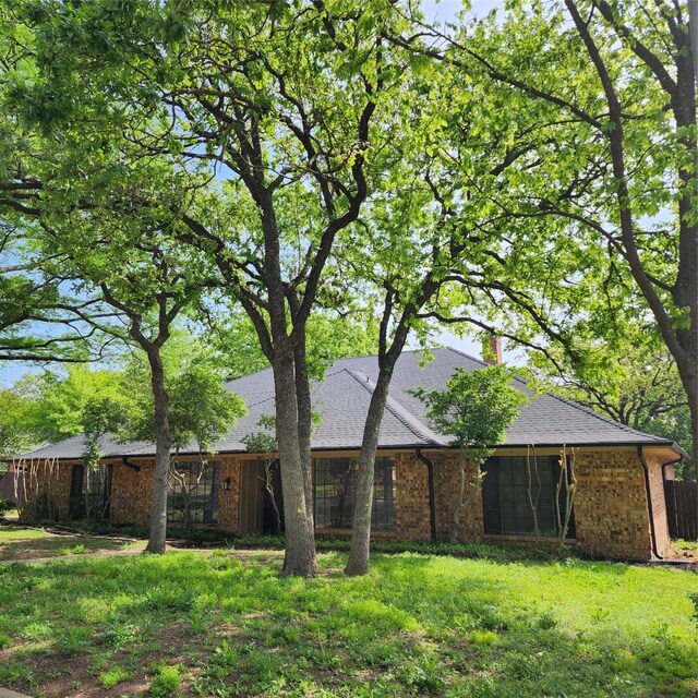 back of house with a lawn