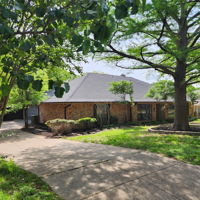 view of home's exterior with a yard and central AC