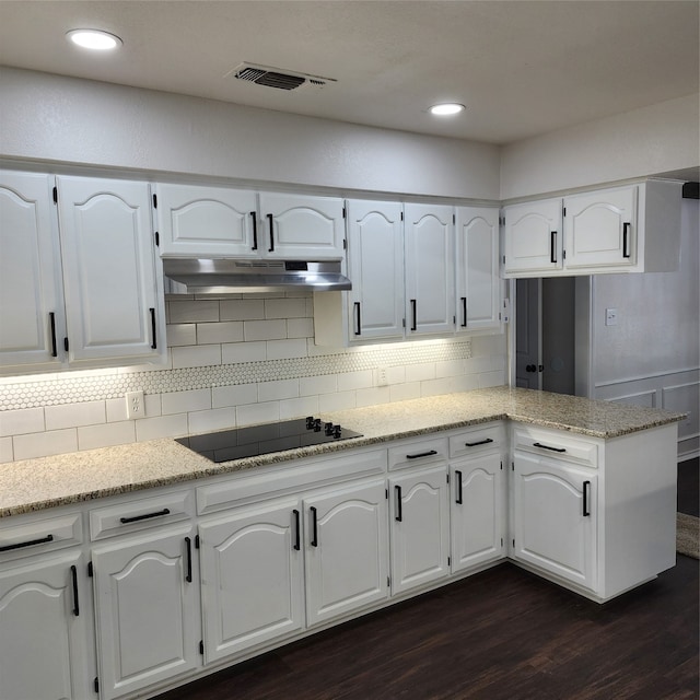 kitchen featuring dark wood-type flooring and white cabinets