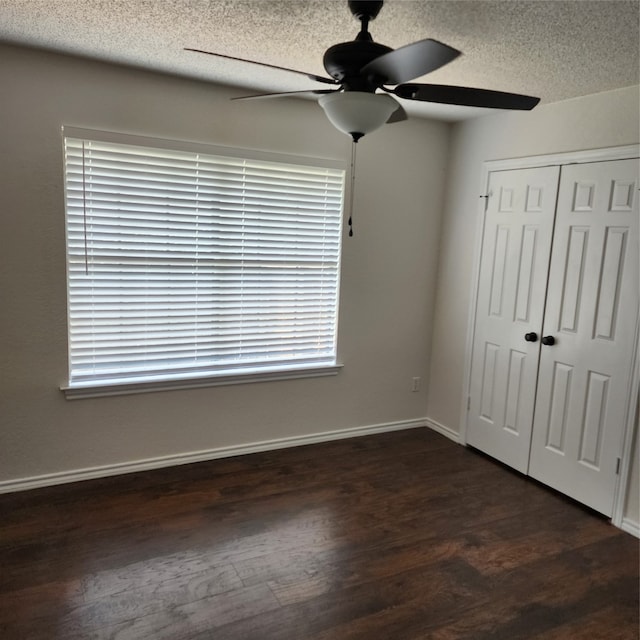 unfurnished bedroom featuring hardwood / wood-style flooring, a closet, a textured ceiling, and ceiling fan