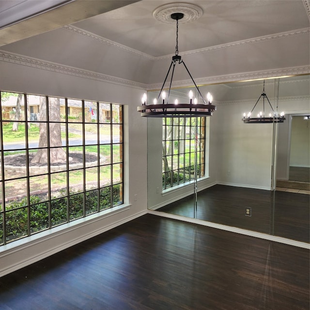 unfurnished dining area featuring a chandelier and wood-type flooring